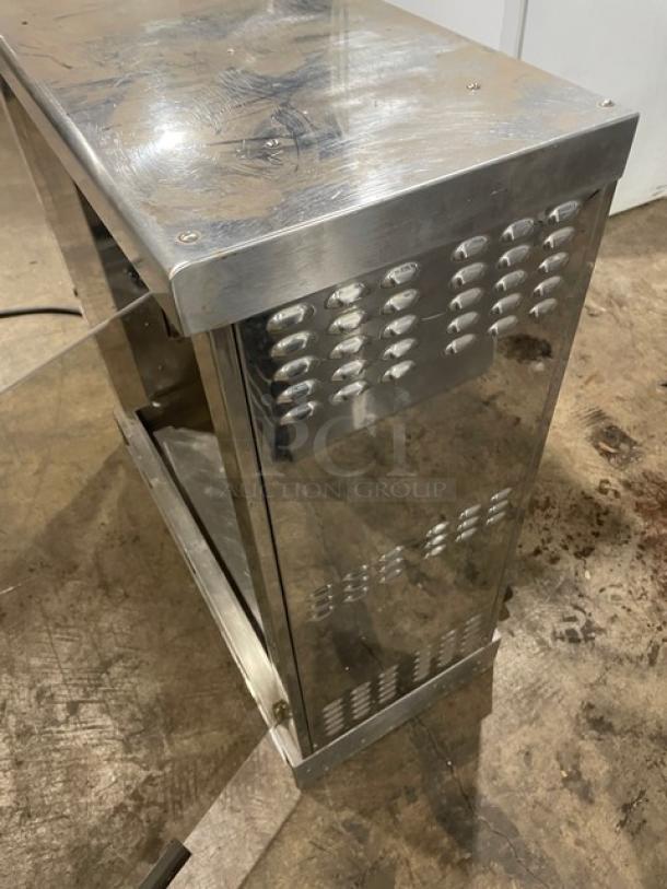 Robot Coupe commercial stainless steel countertop rotisserie cabinet with legs, showing surface wear and vent details.