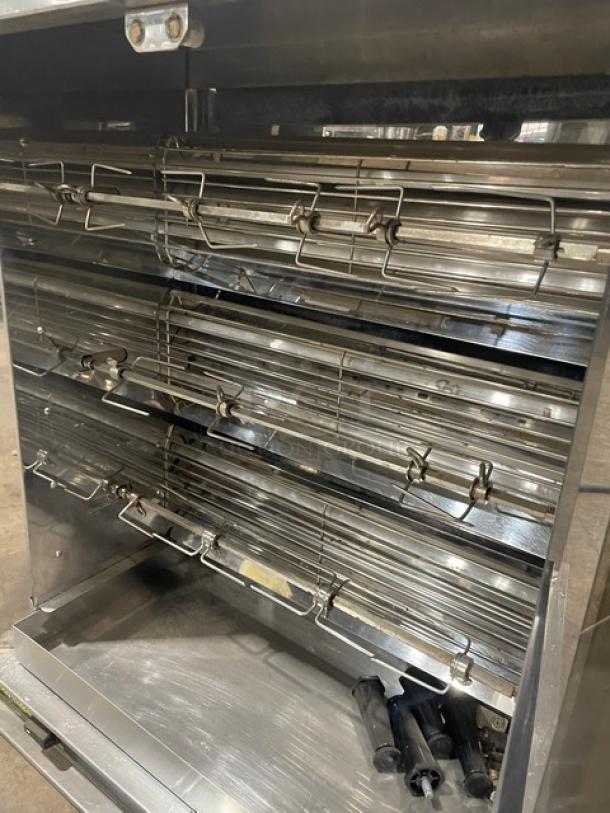 Robot Coupe stainless steel countertop rotisserie cabinet, electric powered, featuring multiple spits and visible legs, in good condition.