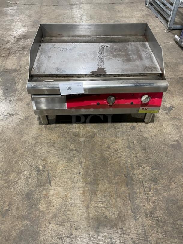 Avantco 24" stainless steel electric countertop griddle, model 177EG24N, with back and side splash, on legs, 208/240V.