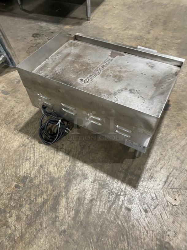 Avantco 177EG24N stainless steel electric countertop 24" flat griddle with back and side splash, 208/240V, on legs.