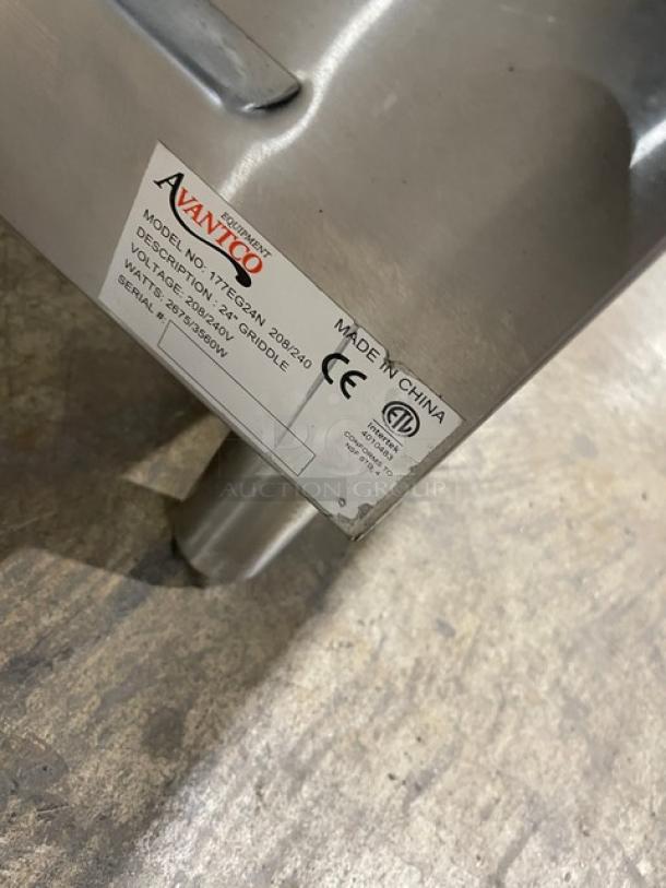 Avantco 177EG24N stainless steel flat griddle with back and side splash, electric, 208/240V, on legs, labeled with specifications.