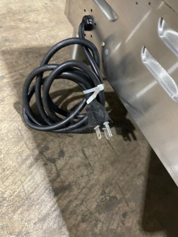 Avantco 24" stainless steel electric countertop griddle, model 177EG24N, with back and side splash, on legs, 208/240V plug.