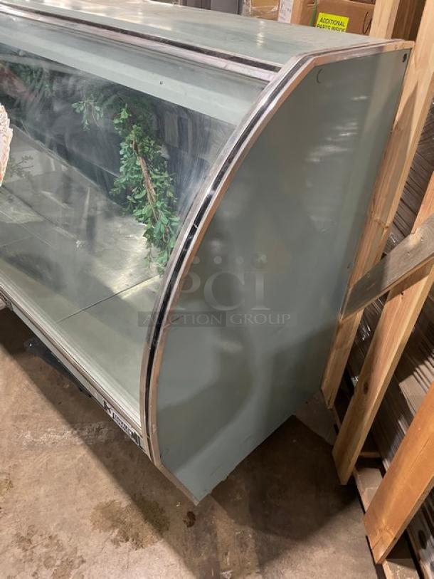 Leader 72" curved glass refrigerated deli merchandiser, model NRHD72SC, with rear sliding doors and lower compartment.