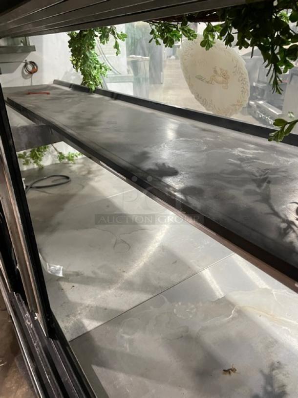 Leader NRHD72SC 72" curved glass deli merchandiser, refrigerated, rear sliding doors, lower overstock compartment, 115V, 1 Phase.