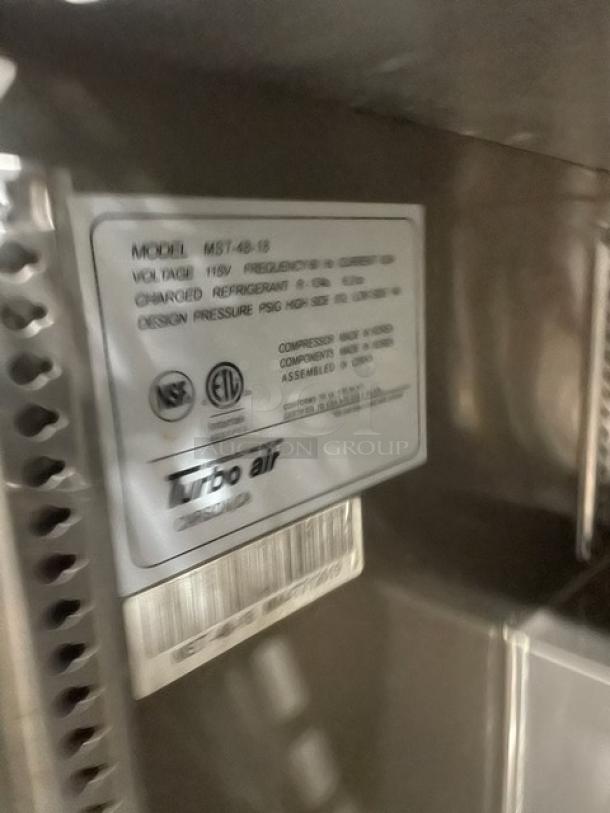 Turbo Air M3 Series MST-48-18 label on stainless steel refrigerated prep table, 115V, NSF/ETL certified, on casters.