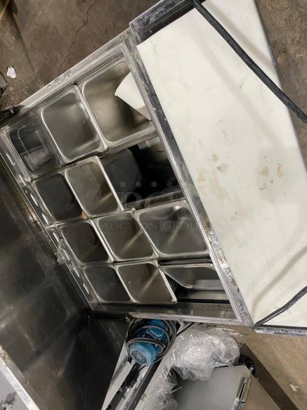 Turbo Air MST-28-12 commercial refrigerated prep table, stainless steel, with cutting board, poly-coated rack, on casters.