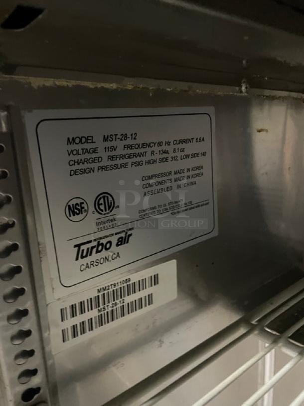 Turbo Air M3 Series MST-28-12 refrigerated prep table label, showing voltage 115V, R-134a refrigerant, and manufacture details.
