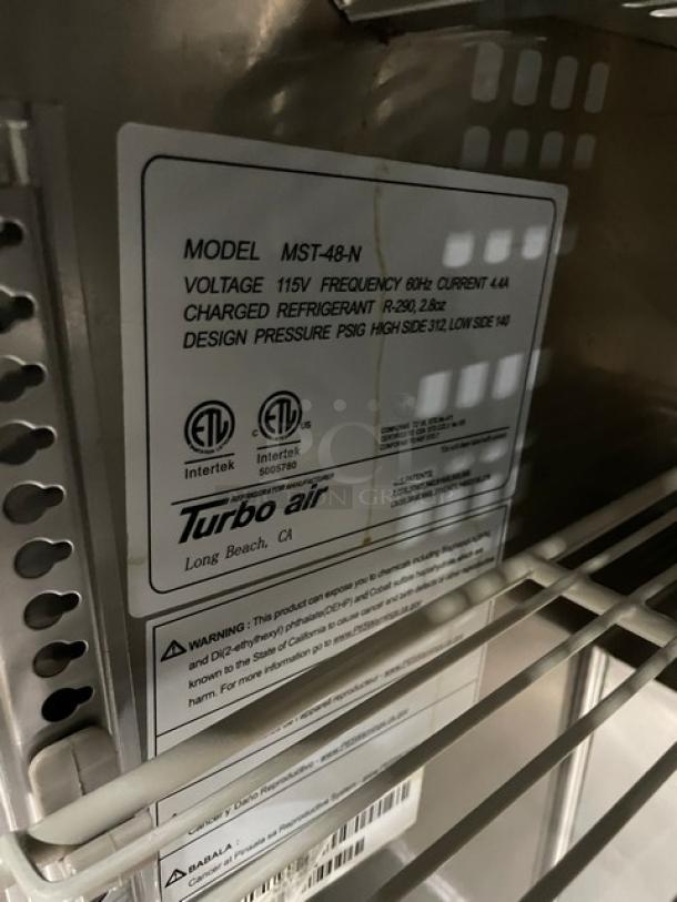 Turbo Air MST-48-N refrigerated prep table, stainless steel, with poly-coated rack. Features 115V, on casters, good condition.