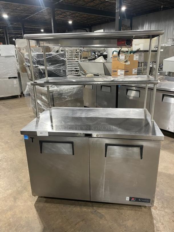 True TUC-48 Worktop Refrigerator, stainless steel, 2-door, Energy Star certified with double overhead shelf, Avantco heat lamp, and poly-coated rack, on casters, model TUC48, SN: 7804002.