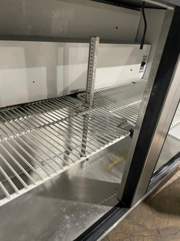 True TUC-48 stainless steel 2-door worktop refrigerator with poly coated wired rack, Energy Star certified, on casters.