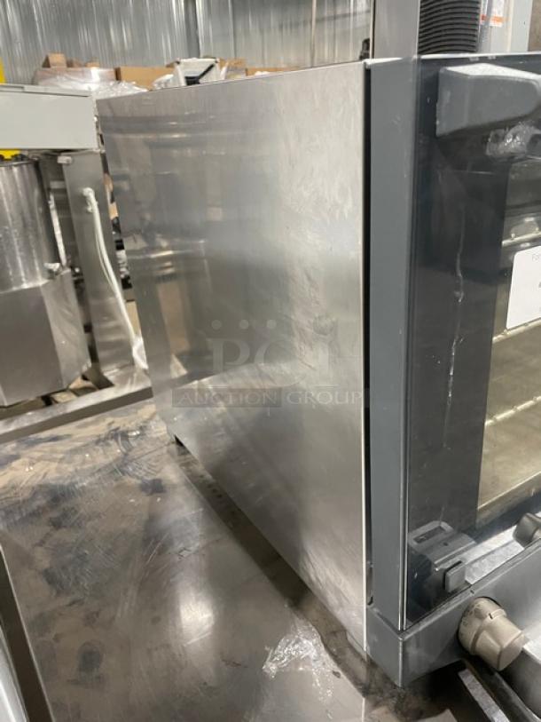 Cadco XAF023 Anna Series countertop convection oven, stainless steel, with wired rack, on legs, 240V, side view.