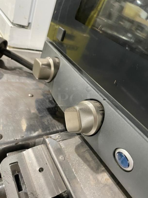 Cadco Anna Series commercial convection oven, model XAF023, with wired rack. Features control knobs, on legs, 240V.