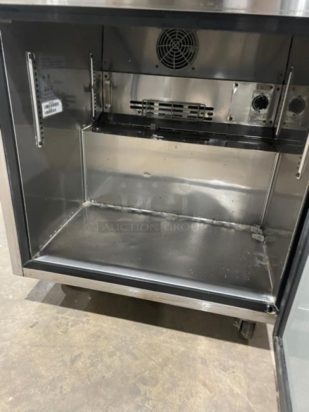 Turbo Air M3 Series stainless steel undercounter refrigerator, model MUR-28, open door, poly coated rack, on casters.