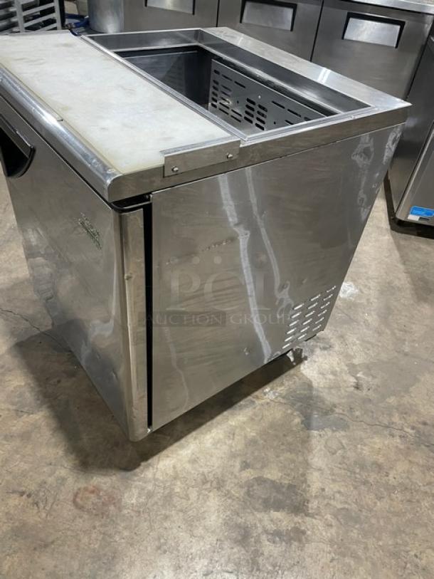 Turbo Air TST-28SD commercial stainless steel single door refrigerated prep table with cutting board, on casters.