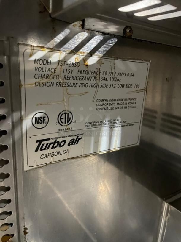 Turbo Air TST-28SD refrigerated salad prep table label detailing model, voltage, refrigerant type, and design pressure.