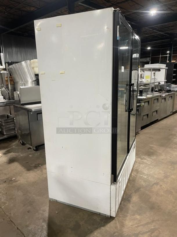 Master-Bilt commercial white double glass swing door merchandiser refrigerator, model BLG-52HD, with poly-coated wired rack.