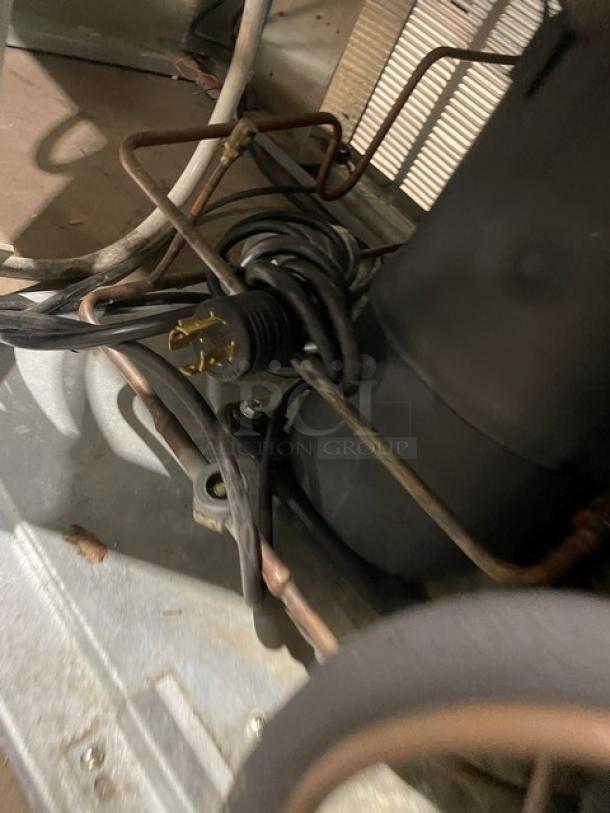 Master-Bilt BLG-52HD commercial refrigerator wiring and compressor detail, showcasing internal components and power plug.