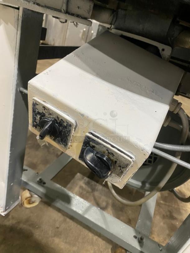 Benier commercial electric conical dough rounder with control switches, mounted on sturdy legs and casters.