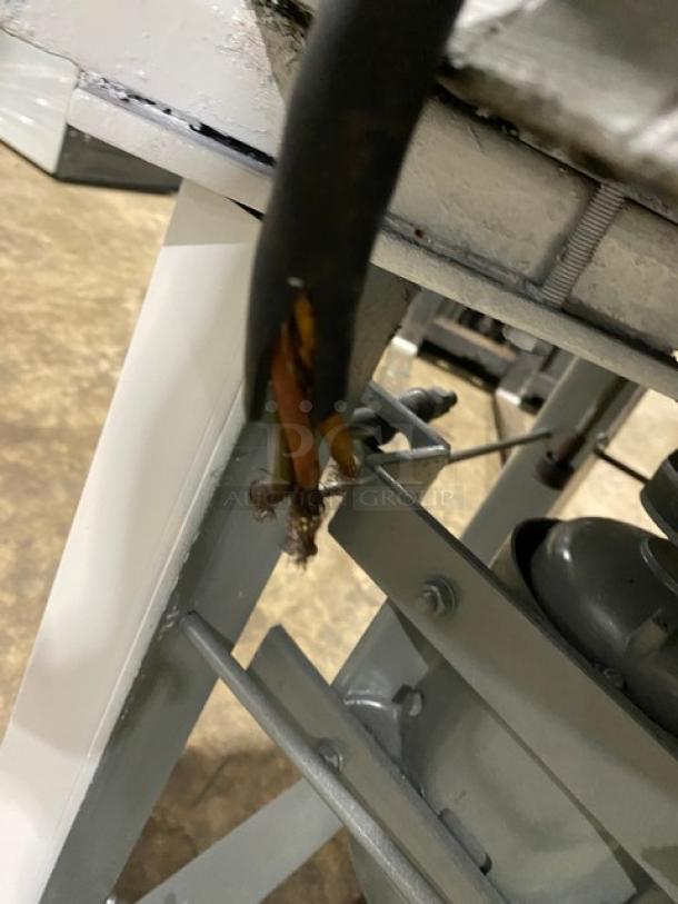 Frayed electrical cord on a Benier commercial dough rounder. Equipment appears worn, with exposed wiring, indicating a need for repairs.