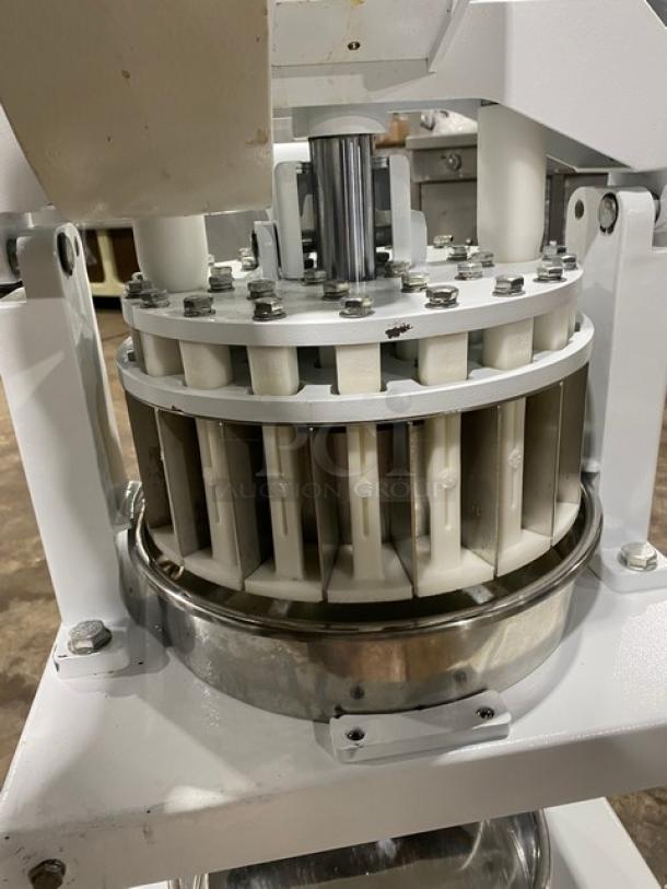 Migsa commercial white manual dough divider with single undershelf. Shown on legs, features metal and plastic components.