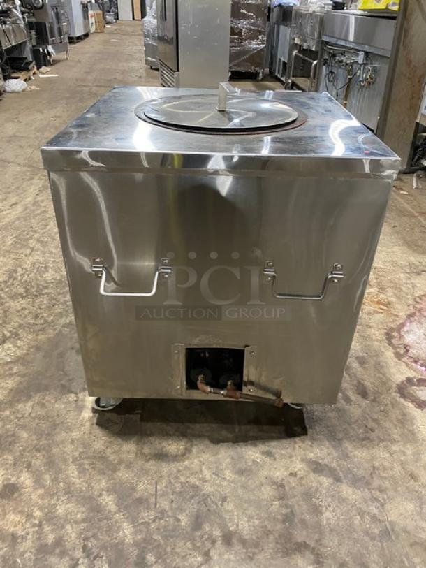 Commercial stainless steel natural gas tandoor oven, on casters, with a lid. Suitable for restaurant use. Good condition.