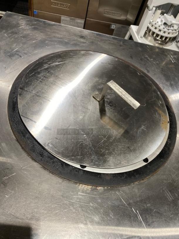 Commercial stainless steel natural gas tandoor oven on casters, featuring a lid with handle, in good condition.