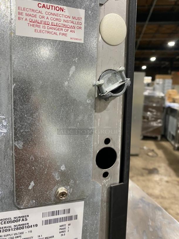 Ice-O-Matic ICE0500FA5 commercial ice maker interior, Energy Star certified, 115V, with caution label and serial number visible.