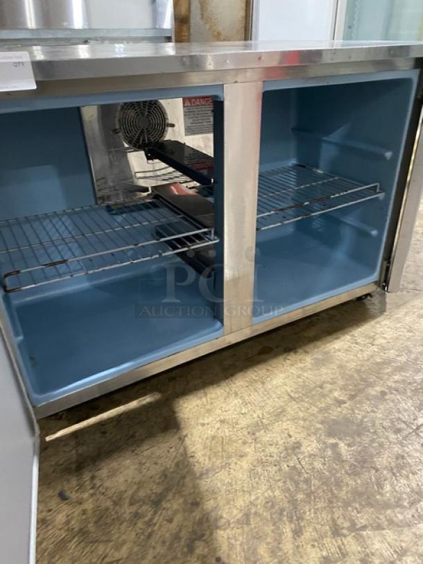 Delfield UC4048P-STAR stainless steel 2-door undercounter refrigerator with coated wire rack and casters, model shown open.