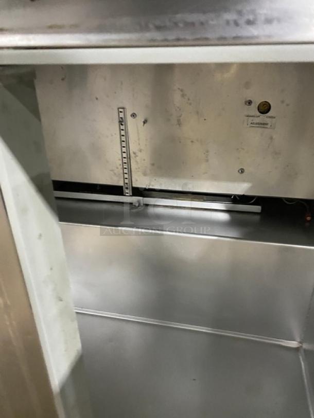 Continental SWF36BS worktop freezer interior, stainless steel, with upturned backsplash, model SN: 15684026, on casters.