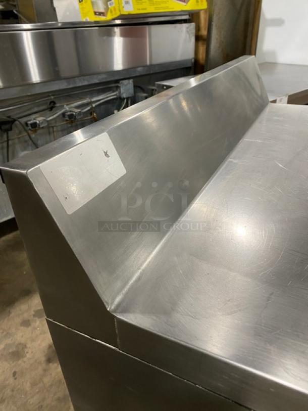 Continental SWF36BS stainless steel 2-door worktop freezer with upturned backsplash, model SWF36-BS, on casters, in used condition.