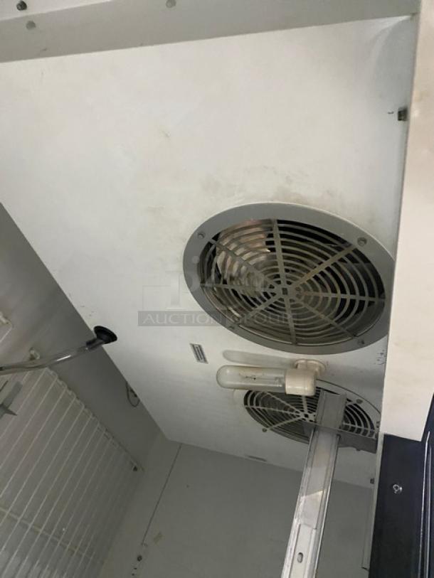 True T-49F commercial stainless steel 2-door reach-in freezer interior, featuring poly coated wire rack and cooling fan.