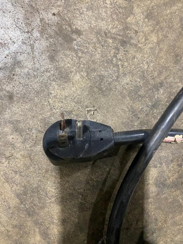 Alt text: Damaged plug of True T-49F commercial stainless steel reach-in freezer, showing exposed wiring.