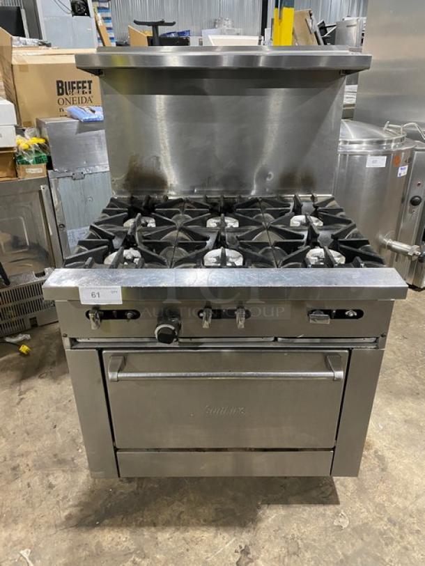 SunFire stainless steel 6-burner gas range/oven combo with back splash, overhead salamander shelf, and wired oven rack on casters.