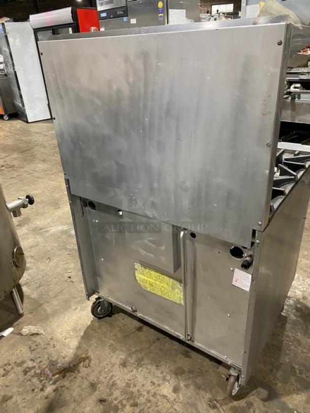 SunFire stainless steel natural gas 6-burner range/oven with back splash, overhead salamander shelf, and casters.