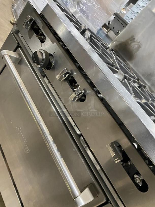 SunFire commercial stainless steel natural gas 6-burner range/oven combo with backsplash, overhead salamander shelf, wired oven rack, on casters.