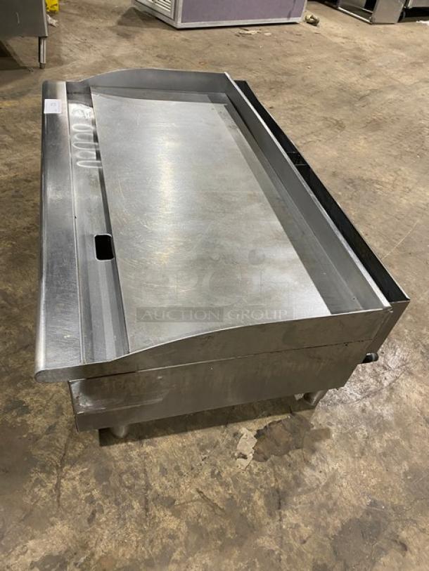 Cecilware Pro Series commercial stainless steel natural gas countertop flat griddle with back and side splash, on legs.