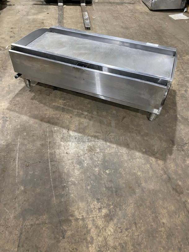 Cecilware Pro Series stainless steel countertop flat griddle with natural gas power, legs, and back and side splash.