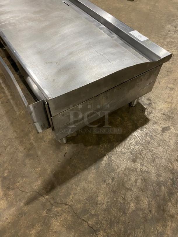 Cecilware Pro Series stainless steel countertop flat griddle with back and side splash, on legs. Natural gas powered.