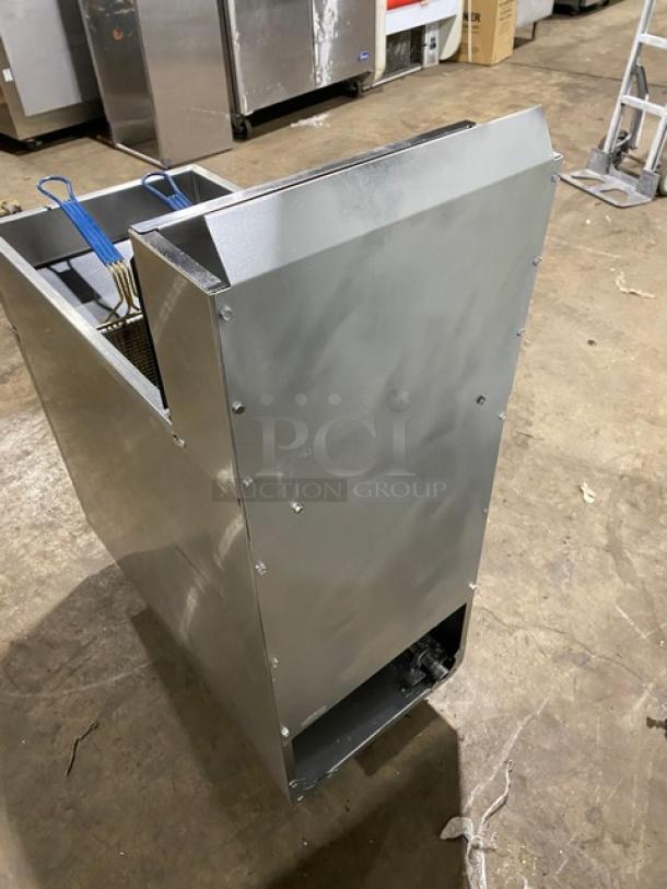 Asber stainless steel gas-powered deep fat fryer with backsplash, basket hanger, and fry basket, on legs.