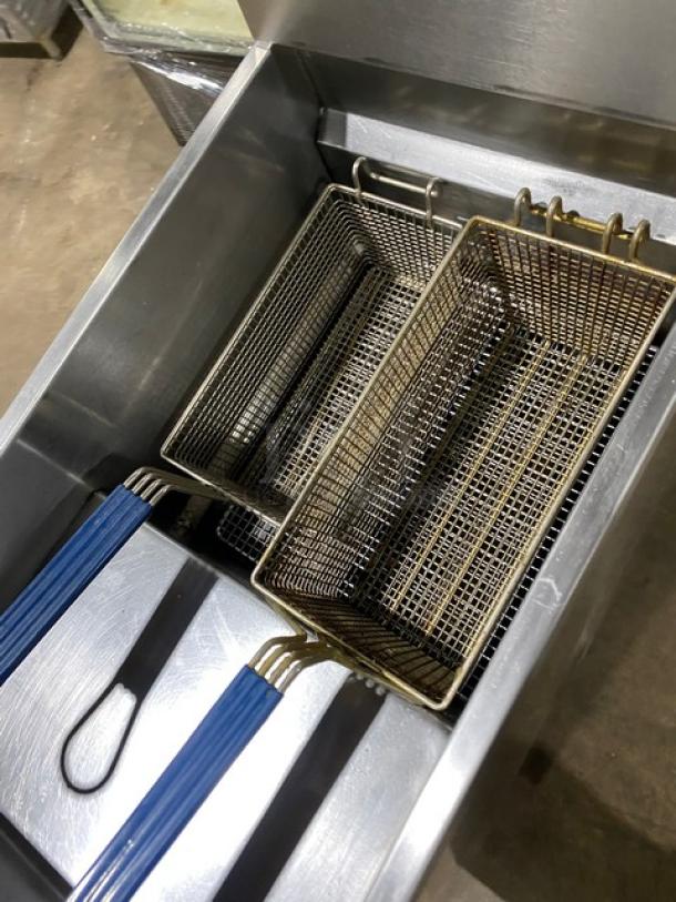 Asber commercial stainless steel gas fryer with back splash, basket hanger, and fry basket on legs. Excellent condition.