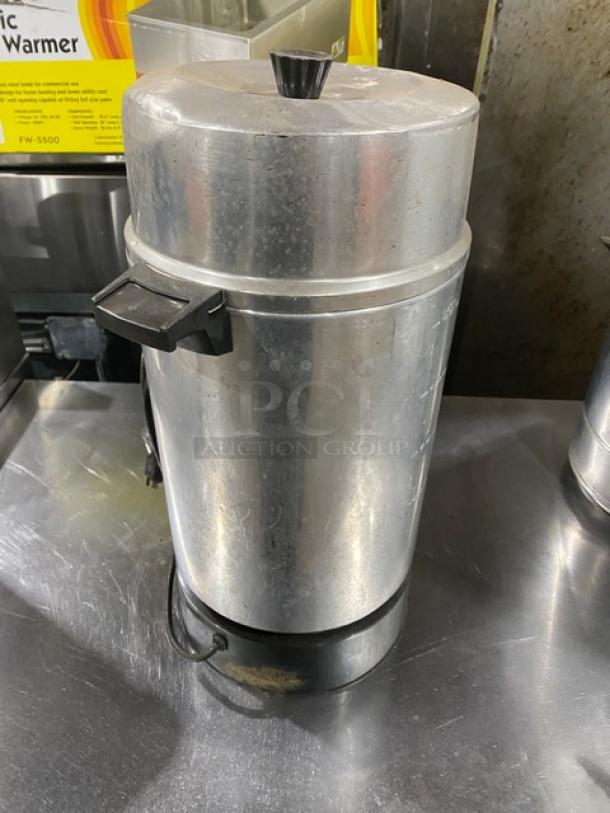 Commercial stainless steel electric coffee urn, insulated, features black handles and plug, good condition, ideal for catering.