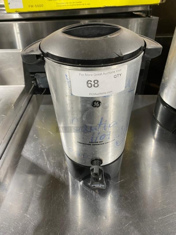 Commercial stainless steel electric coffee urn, insulated, with dispensing spout. Visible label: "68" and PCI Auctions website.