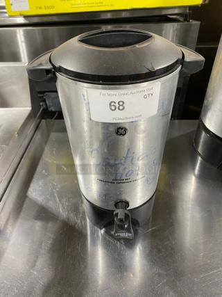Commercial stainless steel electric coffee urn, insulated, with dispensing spout. Visible label: "68" and PCI Auctions website.