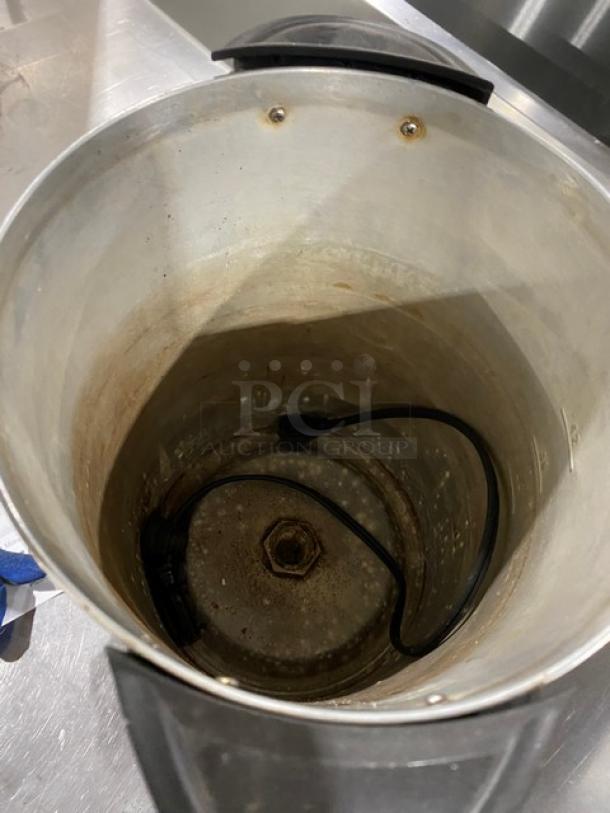 Commercial stainless steel electric coffee urn, insulated, showing interior with power cord. Moderate wear visible.