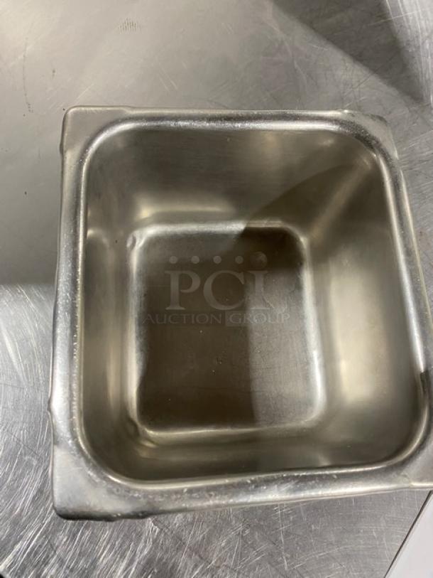 Commercial stainless steel steamtable pan, rectangular, used condition, showing minor surface wear, ideal for hotel use.