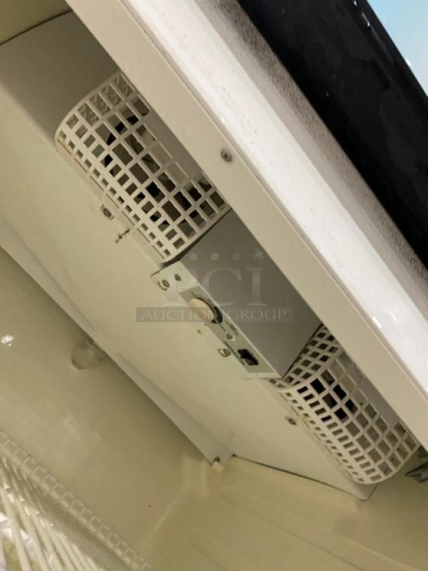 Turbo Air TGM-22RV refrigerator detail showing interior vent, poly-coated wire rack, and white finish; good condition.