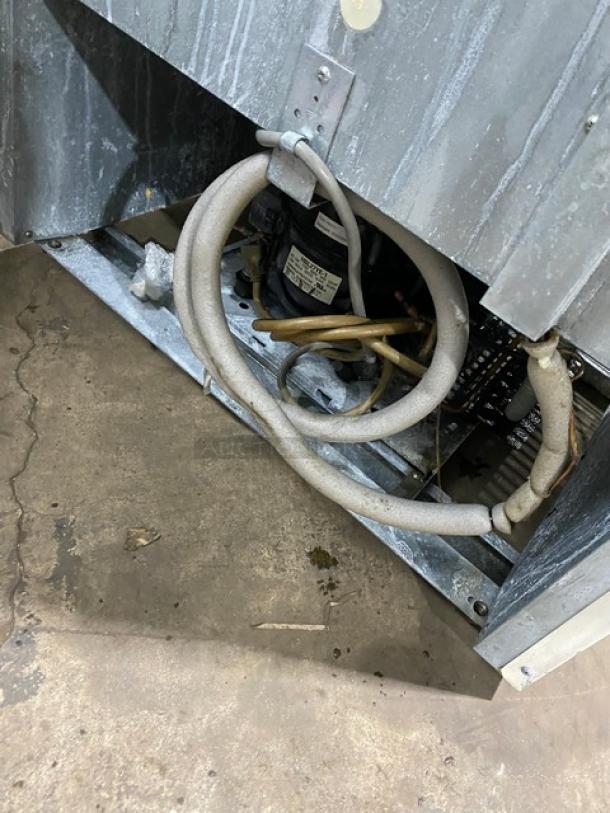 Turbo Air TGM22RV commercial refrigerator, showing wiring and components with metal finish. Model and SN label visible.