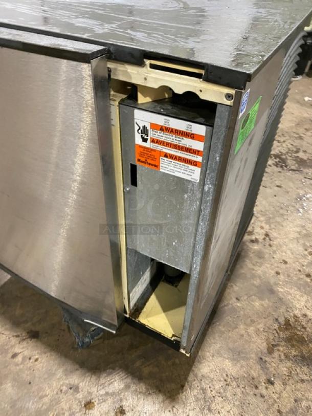 Manitowoc SY0854A stainless steel ice machine head, electric, air-cooled, 208-230V, 1 phase. Visible warning labels.