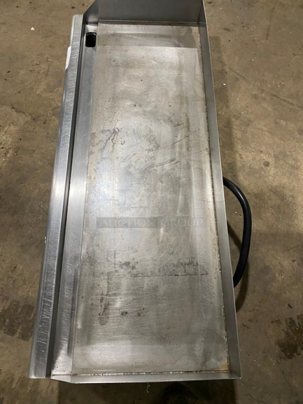 Copper Beech CBETG-48 stainless steel 48" electric griddle with back and side splash, on legs, showing surface wear.