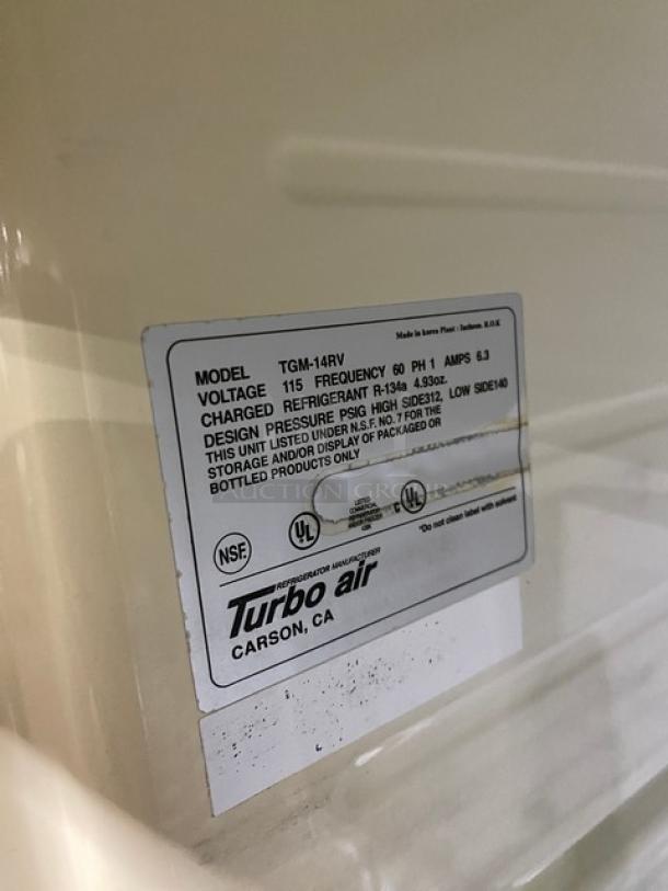 Turbo Air TGM-14RV commercial refrigerator, single glass swing door, white, poly coated rack, 115V, model and voltage label visible.